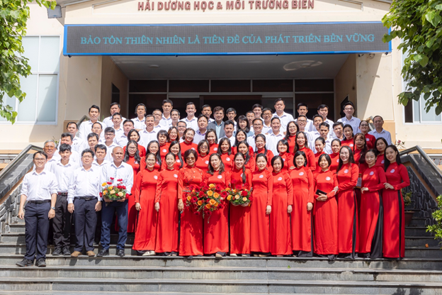 A group of people in red dresses standing on stairsDescription automatically generated